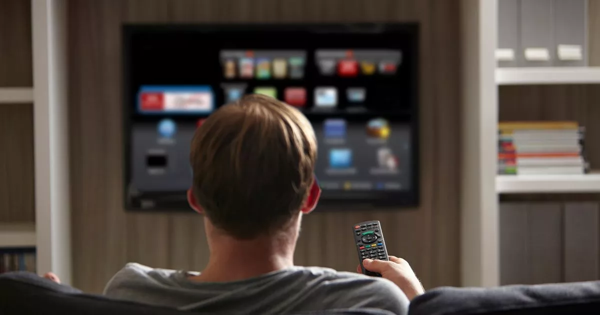 Person watching TV while using Fluxus streaming setup support